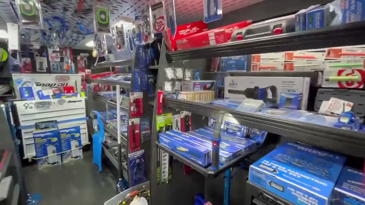 Inside the Tool Co Cornwell mobile tool truck: shelves of hand tools, socket sets, and power tools along the aisle